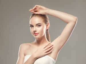 Woman undergoing armpit laser hair removal treatment, showcasing smooth skin and depilation concept in cosmetic body care