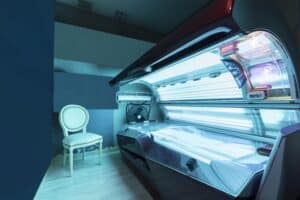 Room with UVA tanning bed for lying down, associated with skin tanning and increased skin cancer risk
