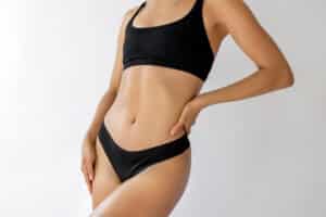 Woman showing body contours after liposuction.